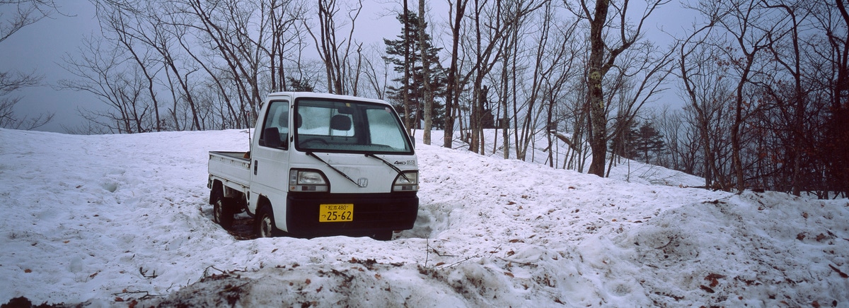 A snowed in Kei truck in Omachi, Japan. Taken by Lucas Taylor on a Hasselblad XPan camera.