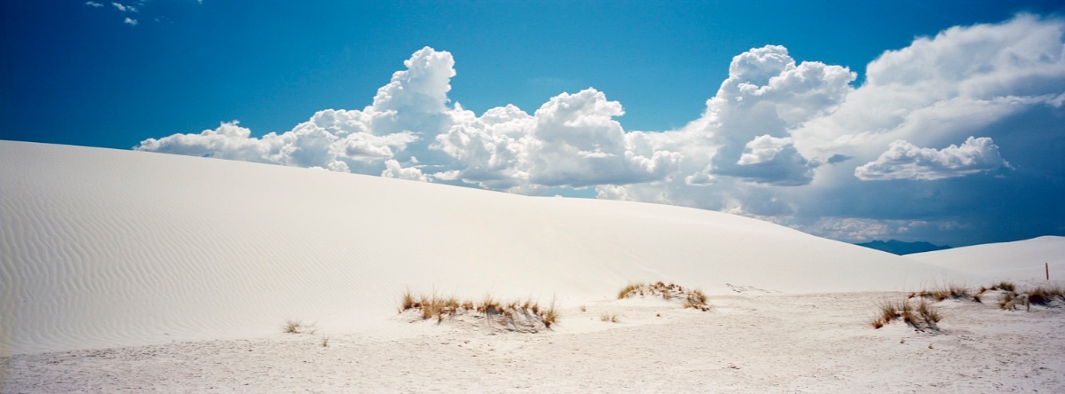 White Sands with dramatic clouds in New Mexico, USA. Taken by Lucas Taylor on a Hasselblad XPan camera.