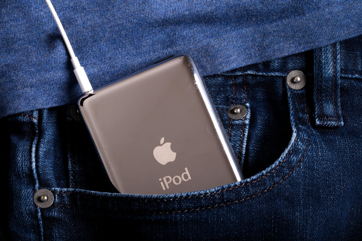 iPod classic connected to earbuds inside the pocket of a pair of jeans