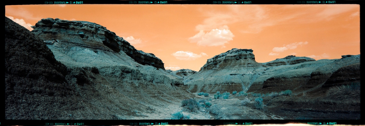6x17 photograph of strange rock formations at Bisti Badlands in New Mexico, USA. Taken by Lucas Taylor on the ND 6x17 camera using Lomo Turquoise film.